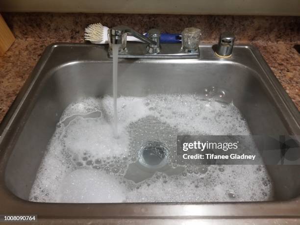 kitchen sink full with soapy water - sink stock pictures, royalty-free photos & images