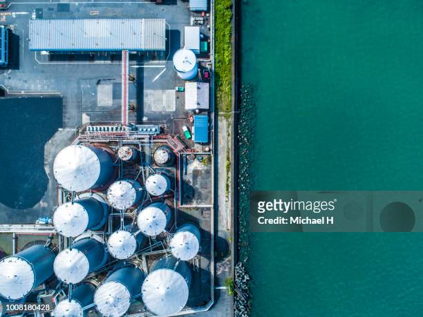 aerial view. piping and tanks of industrial factory - chemische stof stockfoto's en -beelden