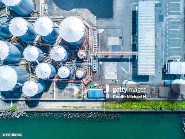 aerial view. piping and tanks of industrial factory - refinery foto e immagini stock