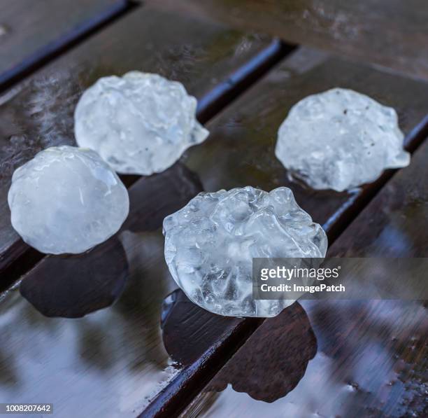 fist sized hailstones from dangerous spring storm - tormenta de granizo fotografías e imágenes de stock