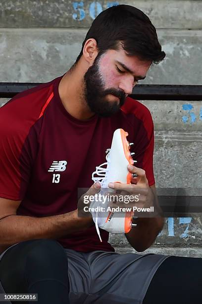 Alisson Becker of Liverpool putting his boots on before a training session on July 31, 2018 in Evian-les-Bains, France.