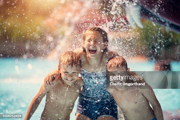 kids having fun in waterpark - bath shower stock pictures, royalty-free photos & images