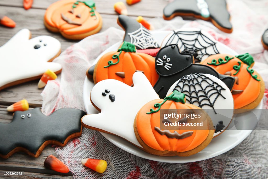 Halloween gingerbread cookies in plate on wooden table