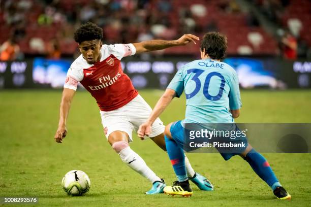 Reiss Nelson of Arsenal battles for the ball against Roberto Olabe of Club Atletico de Madrid during the International Champions Cup 2018 match...