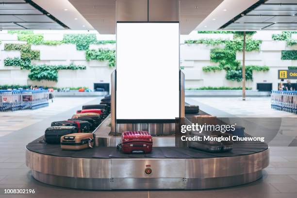 blank advertising billboard with baggage and luggage in the international airport - commercial sign stockfoto's en -beelden