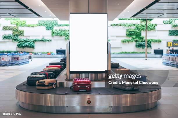 blank advertising billboard with baggage and luggage in the international airport - aeroporto imagens e fotografias de stock