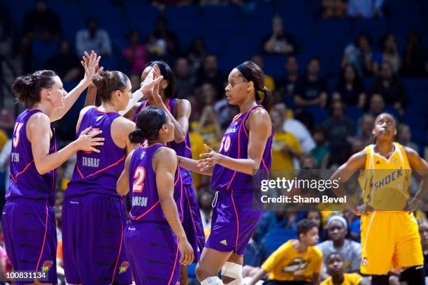 Members of the Phoenix Mercury celebrate in the final minutes while Amber Holt of the Tulsa Shock looks on during the WNBA game on May 25, 2010 at...