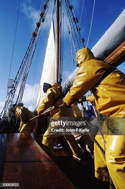 hauling on sheets at schooner in scotland - sailing ship stock pictures, royalty-free photos & images