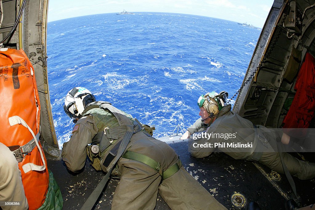 Operation Rimpac UH-3H helicopter crew chief Randall Elkins monitors a landing aboard ...