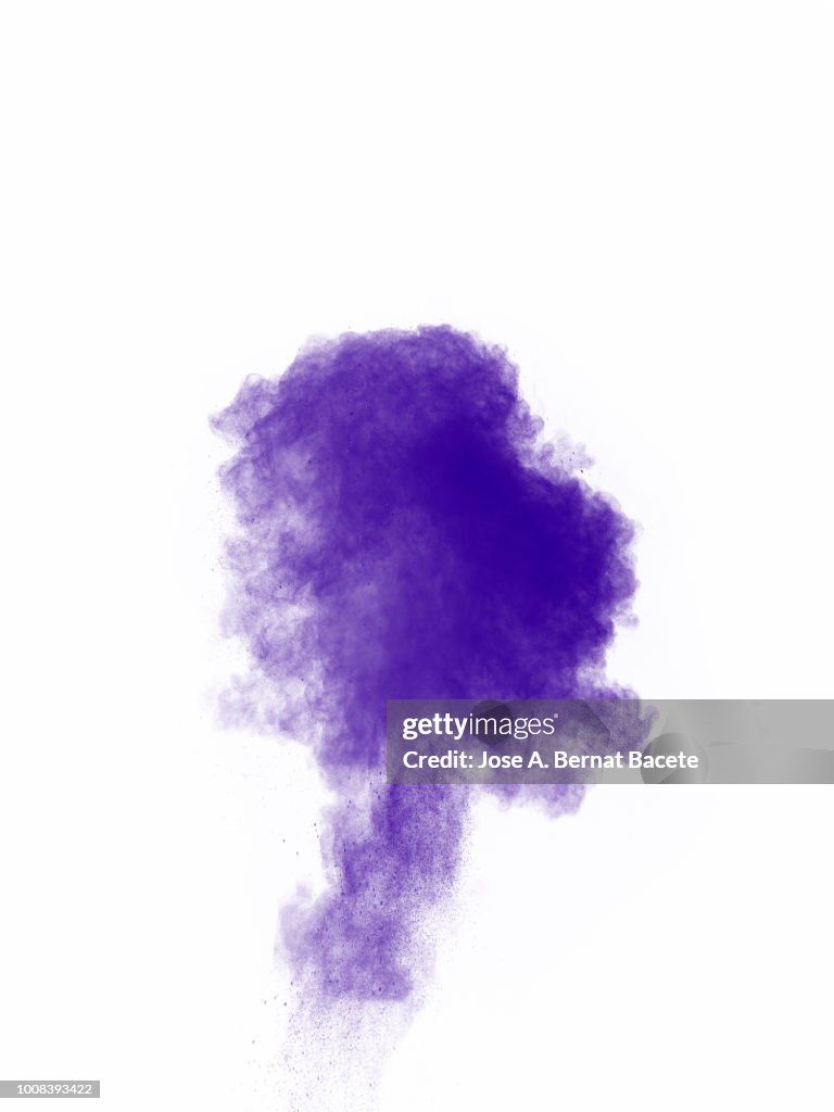 Full frame of forms and textures of an explosion of powder and smoke of color violet and purple on a white background.