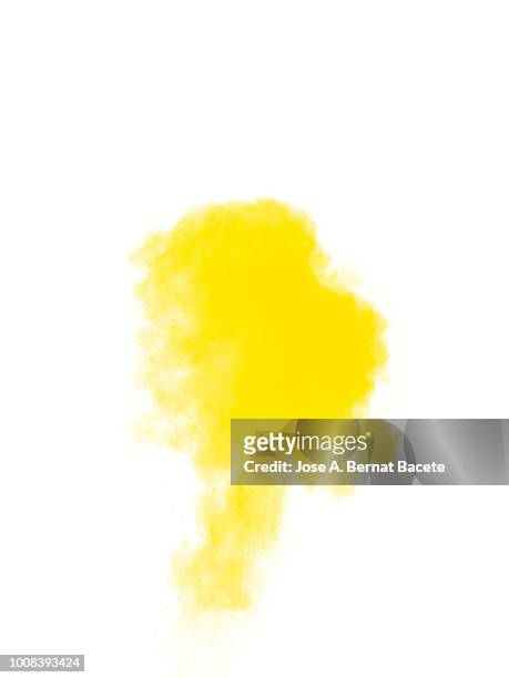 full frame of forms and textures of an explosion of powder and smoke of color yellow on a white background. - yellow smoke stock pictures, royalty-free photos & images