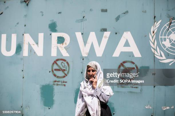 An elderly female protester seen standing outside the gate of the UNRWA office in Gaza. Hundreds of employees of the UN Relief and Works Agency for...