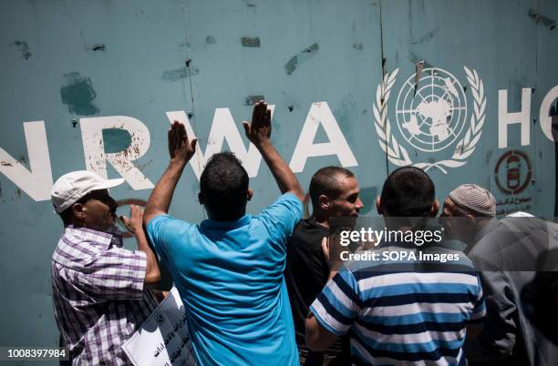 Protesters seen banging on the gate the the UNRWA office. Hundreds of employees of the UN Relief and Works Agency for Palestine Refugees in the Near...