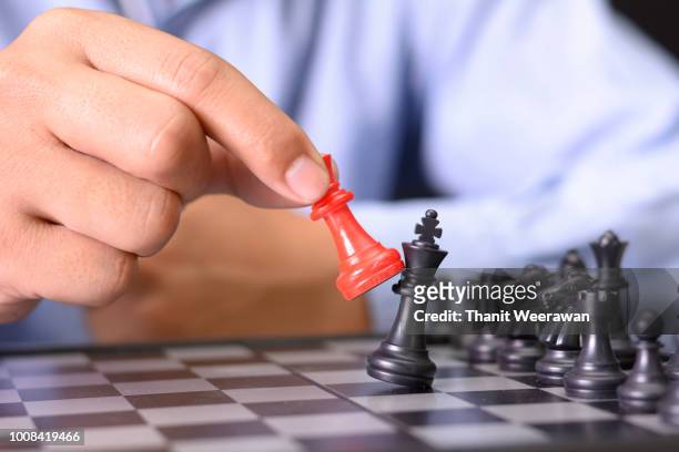 man hand playing chess board, concept of business strategy and tactic - king chess piece stock pictures, royalty-free photos & images