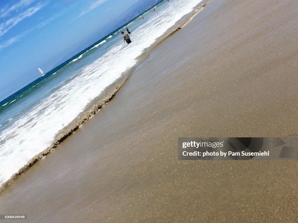 Tilted Angle, Beachgoers with Sand in Focus