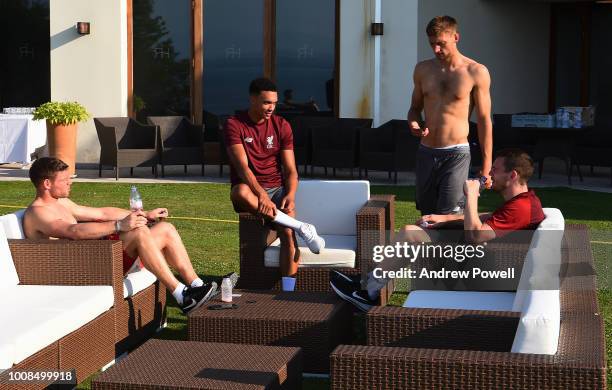 James Milner, Nathaniel Phllips and Andy Robertson meeting Trent Alexander-Arnold of Liverpool on his first day back from international duty to join...