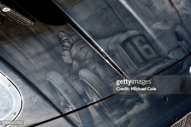 14th July: Vintage Maserati racing car artwork on bonnet of 2014 Maserati MC12 at Goodwood on July 14th, 2018 in Chichester, England.