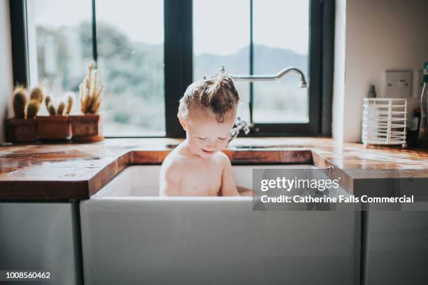 Cute Toddler having a Sink Bath