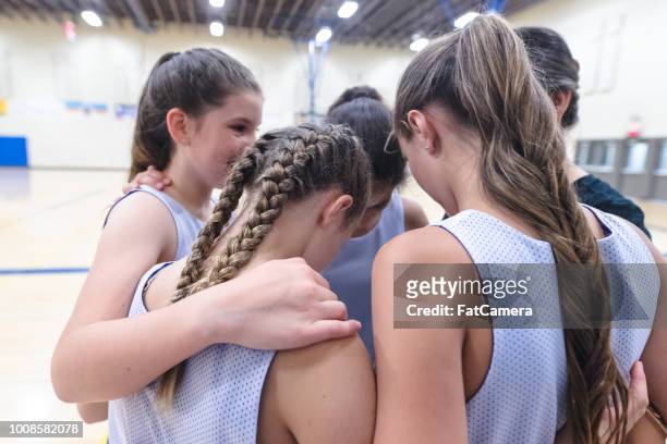 girls basketball coach leads a pre-game huddle - basketball sport team stock pictures, royalty-free photos & images