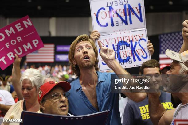 People make themselves heard as CNN broadcasts before the arrival of President Donald Trump for his Make America Great Again Rally at the Florida...