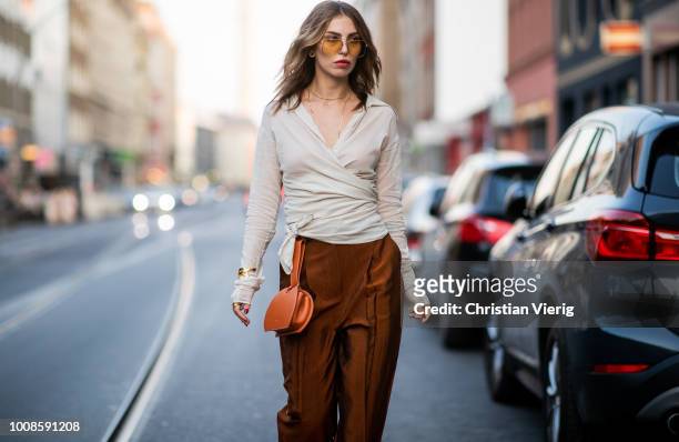 Masha Sedgwick wearing blouse Massimo Dutti, H&M pants, Tory Burch platform sandals, Polene bag, Chloe sunglasses on July 31, 2018 in Berlin, Germany.