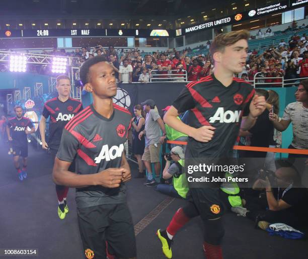 Joshua Bohui and James Garner of Manchester United heads out to warm up ahead of the pre-season friendly match between Manchester United and Real...