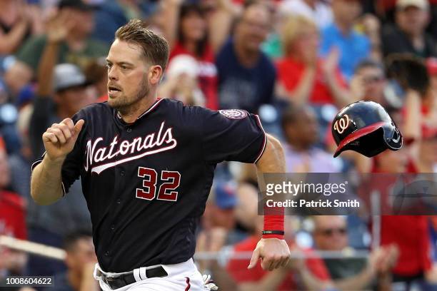 Matt Wieters of the Washington Nationals loses his helmet as he runs to score a run against the New York Mets during the first inning at Nationals...