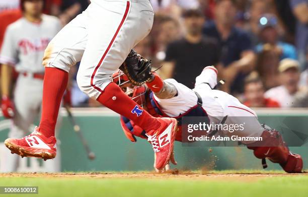 Maikel Franco of the Philadelphia Phillies evades the tag at home plate by Blake Swihart of the Boston Red Sox to score in the fourth inning of a...