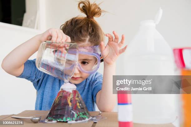 girl making volcano - child discovering science stockfoto's en -beelden