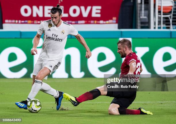 Gareth Bale of Real Madrid in action past Luke Shaw of Manchester United during the International Champions Cup match at Hard Rock Stadium on July...