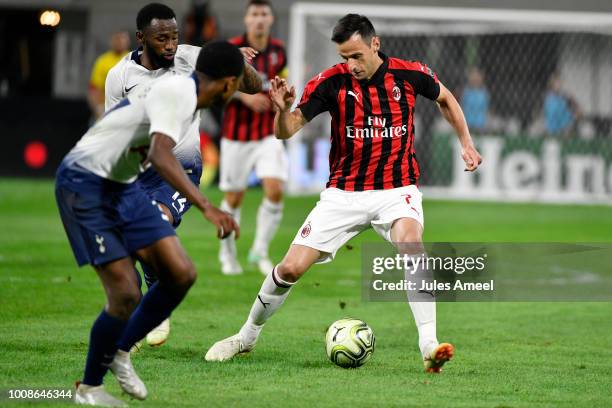 Nikola Kalinic of AC Milan advances the ball past Georges-Kévin N'Koudou of the Tottenham Hotspur during the second half of the International...