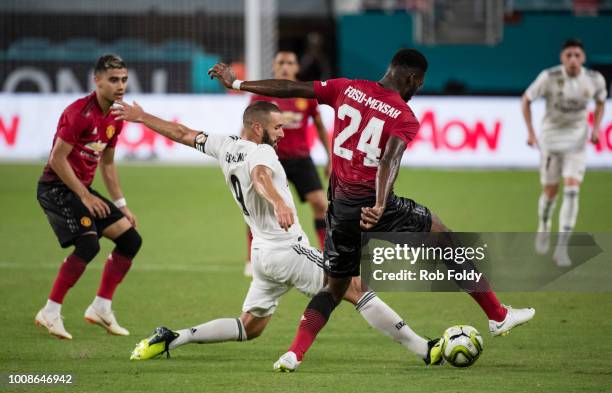 Karim Benzema of Real Madrid and Timothy Fosu-Mensah of Manchester United reach for the ball during the International Champions Cup match at Hard...