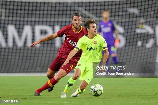 Barcelona midfielder Ricky Puig is tripped from behind by AS Roma midfielder Lorenzo Pellegrini during the International Champions Cup between FC...