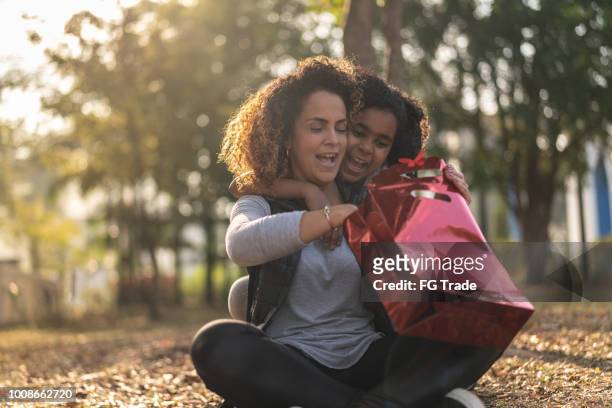 daughter giving a gift for your her mother - open day 8 stock pictures, royalty-free photos & images
