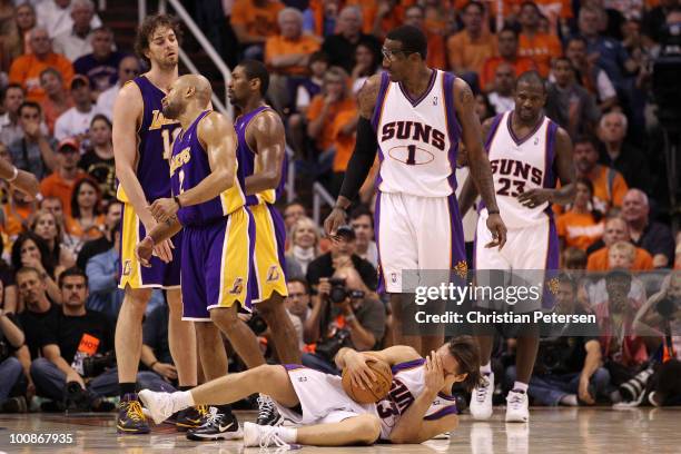 Steve Nash of the Phoenix Suns lays on the court after being fouled in the face by Derek Fisher of the Los Angeles Lakers in the third quarter of...