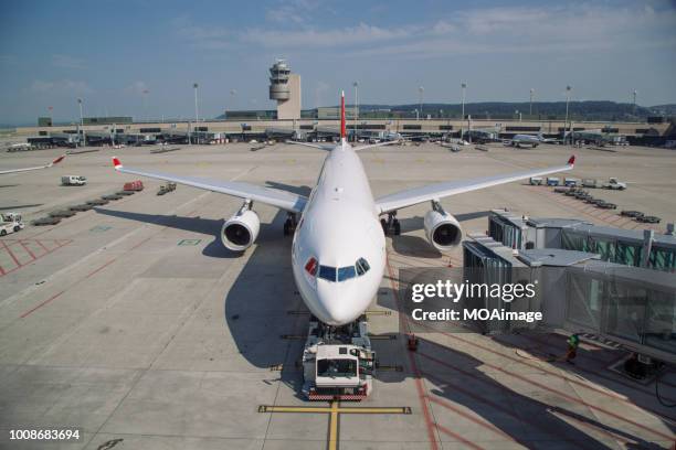 an airplane parked on the runway - flugfeld stock-fotos und bilder