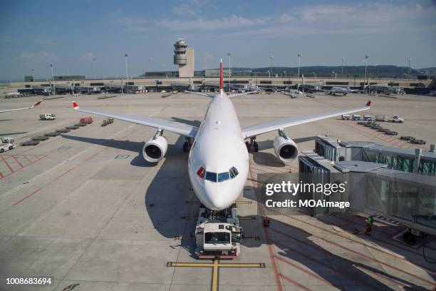 an airplane parked on the runway - air strip stock pictures, royalty-free photos & images