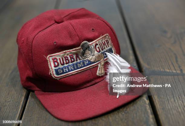 Bubba Gump cap worn by Tom Hanks in the film Forrest Gump alongside a feather from the same film in the Prop Store head office near Rickmansworth...