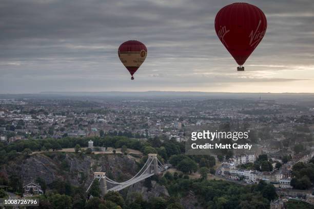 Hot air balloons fly over the Clifton Suspension Bridge after launching from Ashton Court at a preview flight to launch next week's Bristol...
