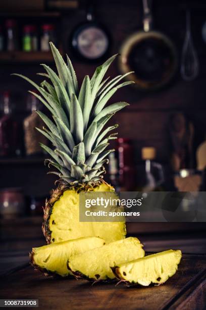 fresh tropical sliced  pineapple on chopping board. natural lighting - chopped stock pictures, royalty-free photos & images