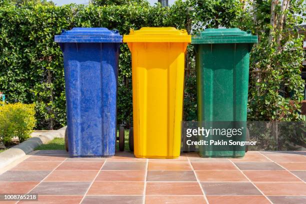 colorful plastic bins for different waste types - color coded stockfoto's en -beelden