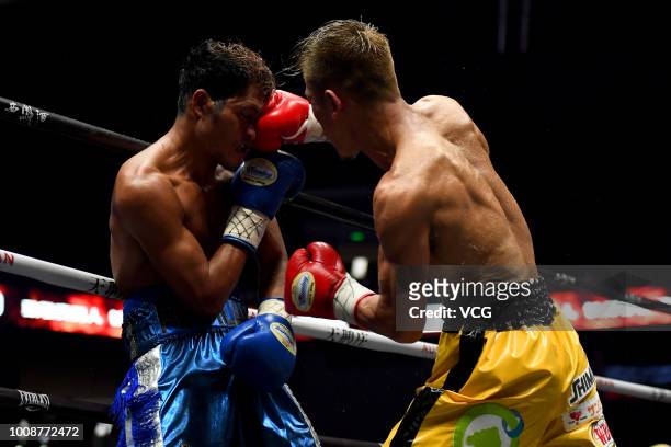 Japanese boxer Sho Kimura punches Filipino challenger Froilan Saludar during WBO Flyweight Title Bout at Qingdao Guosen Gymnasium on July 27, 2018 in...