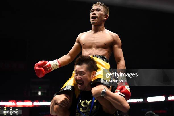 Japanese boxer Sho Kimura celebrates after defeating Filipino challenger Froilan Saludar during WBO Flyweight Title Bout at Qingdao Guosen Gymnasium...