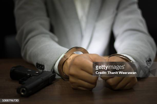 businessmen arrested,businessman with handcuffs - restraining order stock pictures, royalty-free photos & images