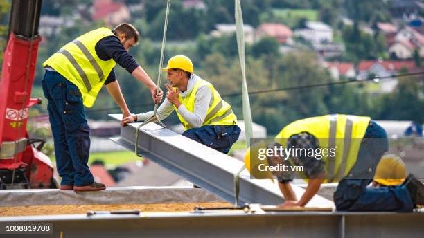 construction workers on a girder - girder stock pictures, royalty-free photos & images