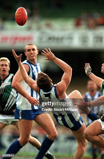 Adam Simpson, number seven for the Kangaroos attempts to take a falling mark, during the match between the Kangaroos and Port Adelaide, during round...