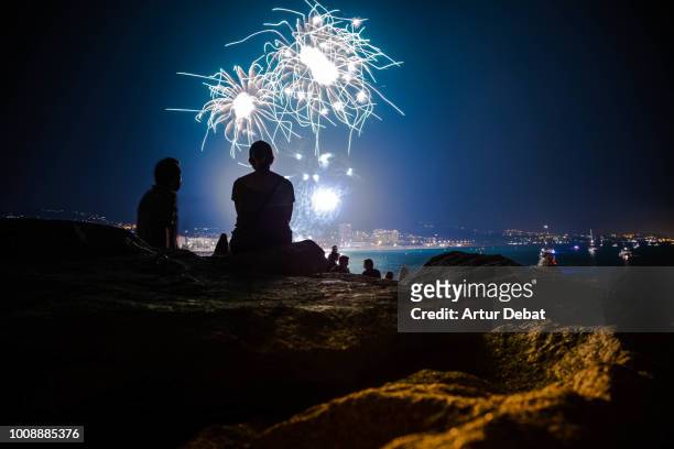 people contemplating fireworks. - barcelona night stockfoto's en -beelden