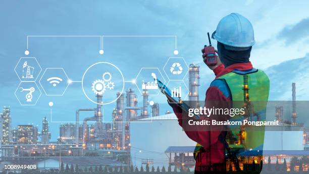 double exposure of technician engineer with safety helmet with oil refinery industry plant background - gas engineer stockfoto's en -beelden
