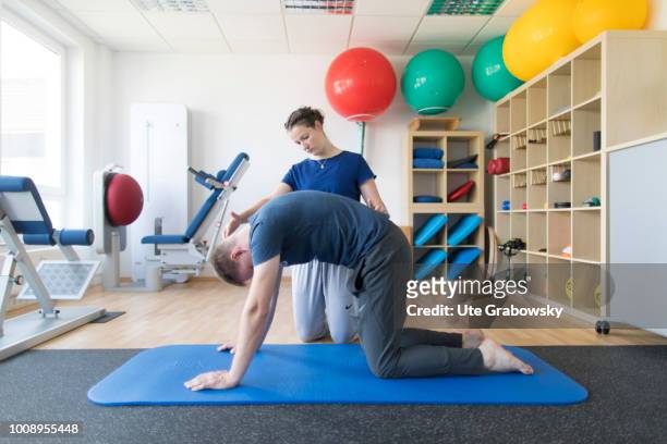 May 25: Physiotherapist and patient undergoing treatment in a physiotherapy practice on May 25, 2018 in BONN, GERMANY.