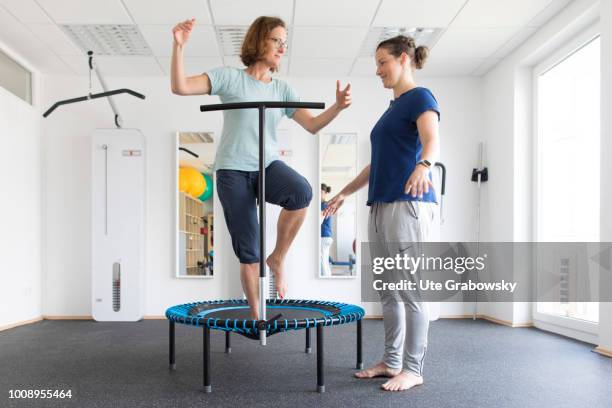 May 25: Physiotherapist and patient undergoing treatment in a physiotherapeutic practice on May 25, 2018 in BONN, GERMANY. Balance training on a...